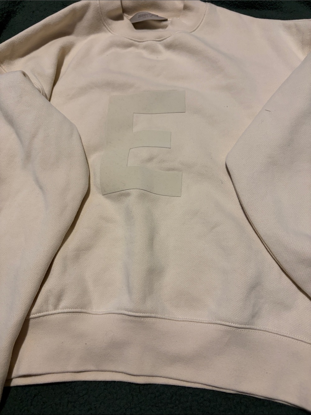 Essentials Kids Crewneck Sweatshirt in Light Cream with Embossed E